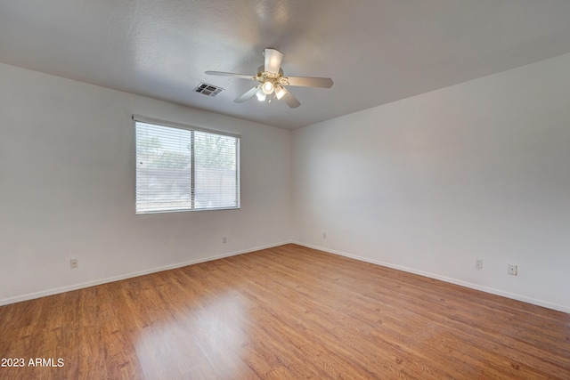 empty room featuring ceiling fan and light hardwood / wood-style flooring