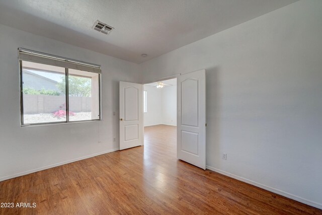 unfurnished room with ceiling fan and light hardwood / wood-style flooring