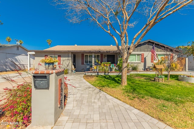 ranch-style home with a front lawn