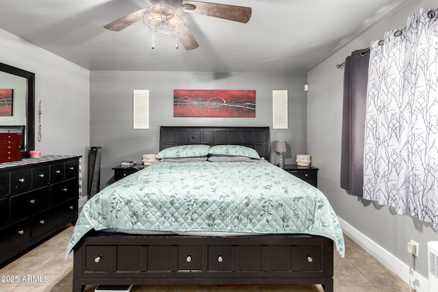 bedroom with a ceiling fan, baseboards, and light tile patterned floors