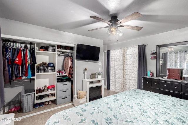 bedroom featuring a ceiling fan, a closet, and tile patterned floors