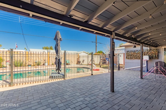 view of patio with fence and a fenced in pool