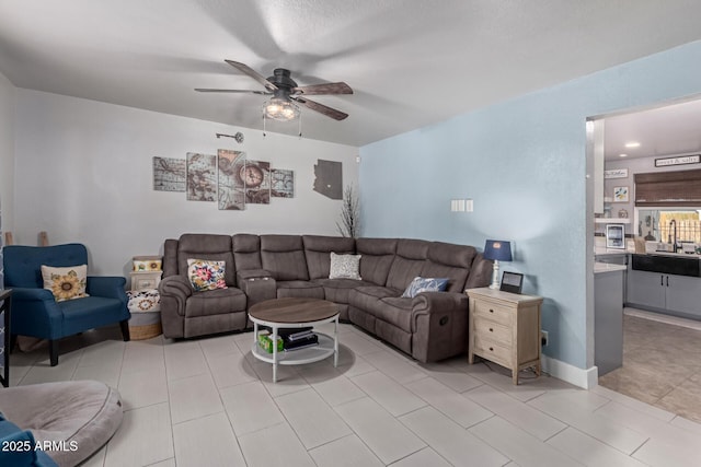 living room with a ceiling fan and light tile patterned floors