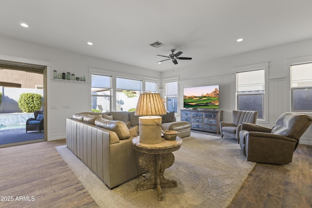 living area with visible vents, recessed lighting, and wood finished floors