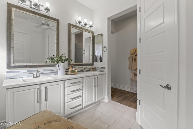 full bathroom featuring a sink, a ceiling fan, tasteful backsplash, and double vanity