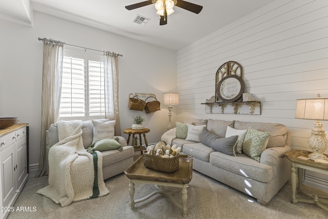 living room featuring visible vents and a ceiling fan