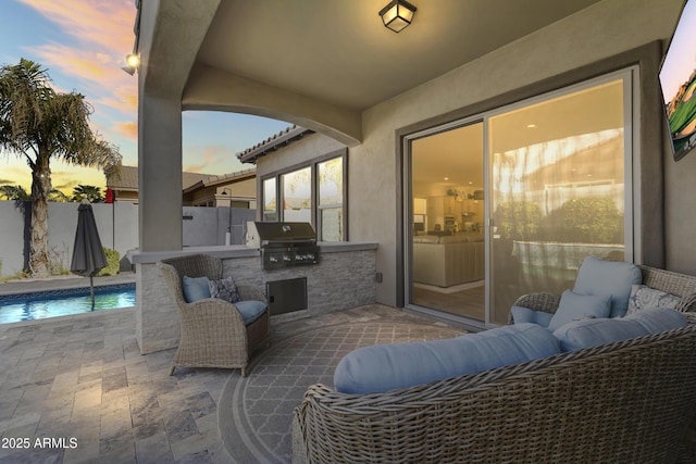 patio terrace at dusk with grilling area, a fenced in pool, fence, an outdoor hangout area, and area for grilling