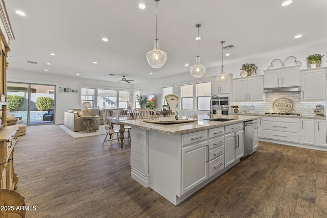 kitchen featuring a sink, dark wood-style floors, open floor plan, and white cabinetry