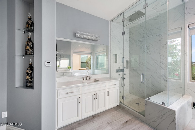 bathroom with vanity and a shower with door