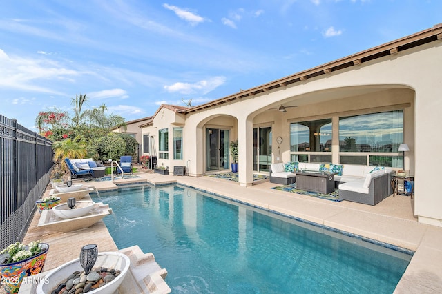 view of swimming pool featuring outdoor lounge area, ceiling fan, and a patio area