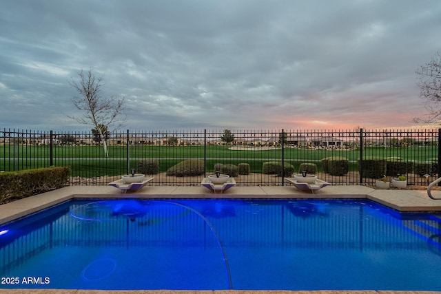 view of swimming pool featuring a patio area, a fenced in pool, and fence