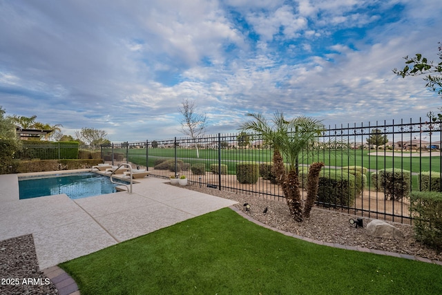 view of pool with a fenced in pool, a yard, a patio area, and fence