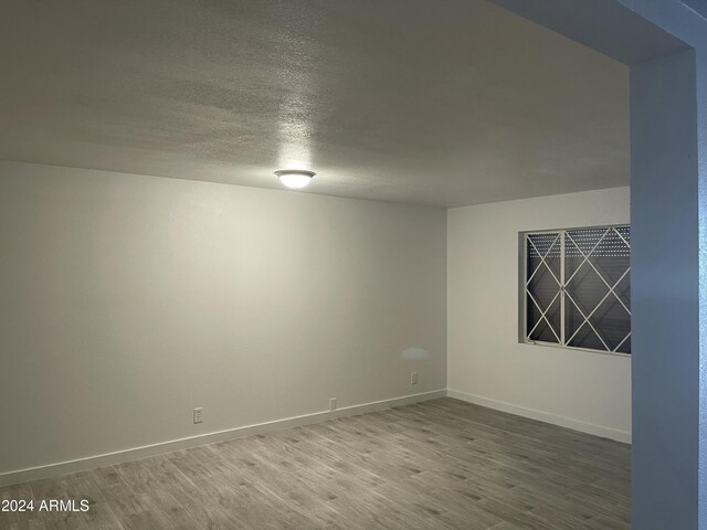 unfurnished room featuring hardwood / wood-style floors