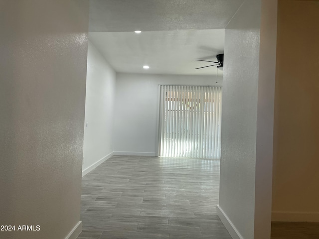 corridor with light hardwood / wood-style flooring