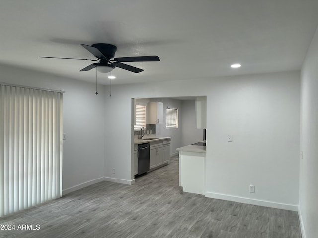 interior space with ceiling fan, sink, and light hardwood / wood-style floors