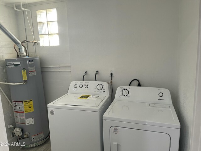 laundry room with washing machine and dryer and gas water heater