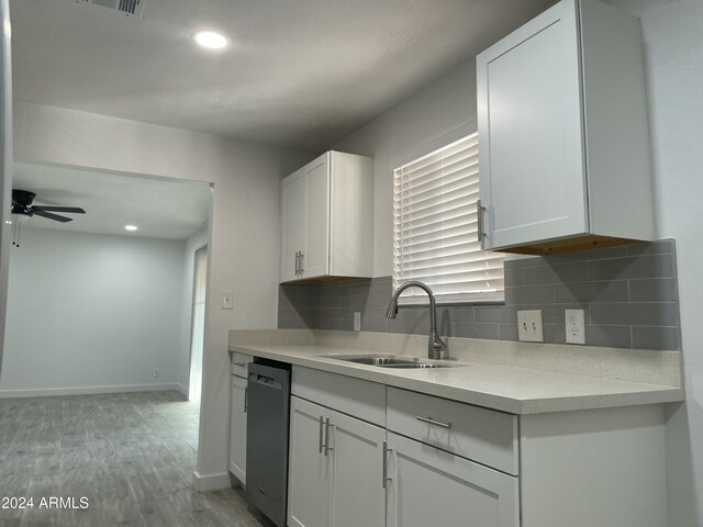 kitchen featuring ceiling fan, dishwasher, white cabinets, and sink