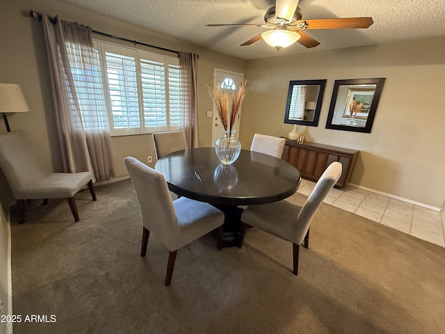 carpeted dining area featuring ceiling fan and a textured ceiling