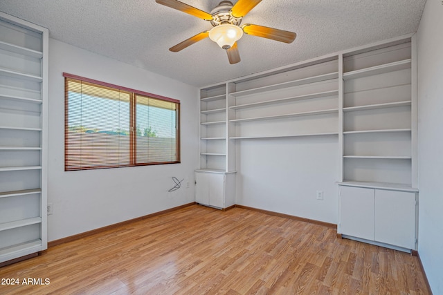 unfurnished bedroom featuring ceiling fan, light hardwood / wood-style floors, and a textured ceiling