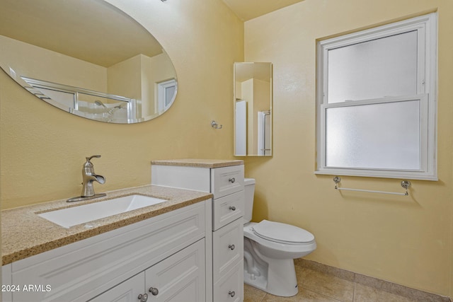 bathroom with tile patterned floors, toilet, an enclosed shower, and vanity