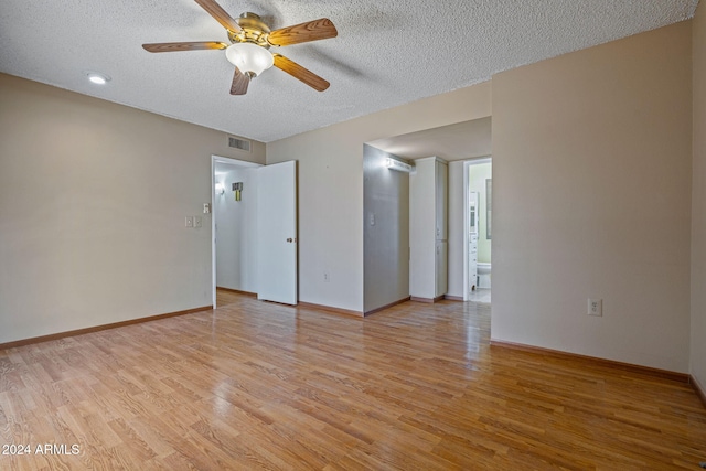 unfurnished room with light wood-type flooring, a textured ceiling, and ceiling fan