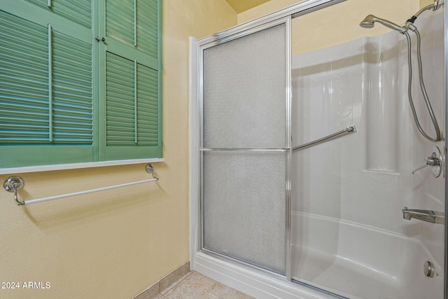 bathroom with tile patterned flooring and walk in shower