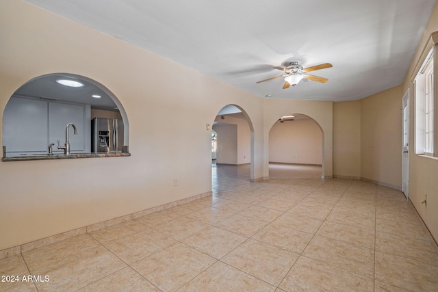 spare room featuring ceiling fan and light tile patterned flooring