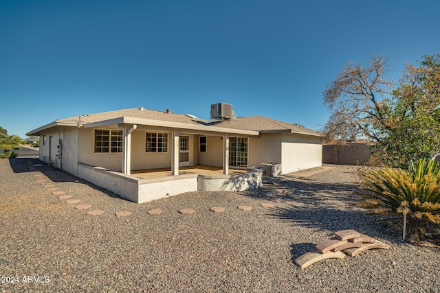 rear view of house featuring cooling unit and a patio area