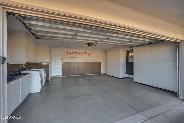 garage featuring washer and dryer and a garage door opener