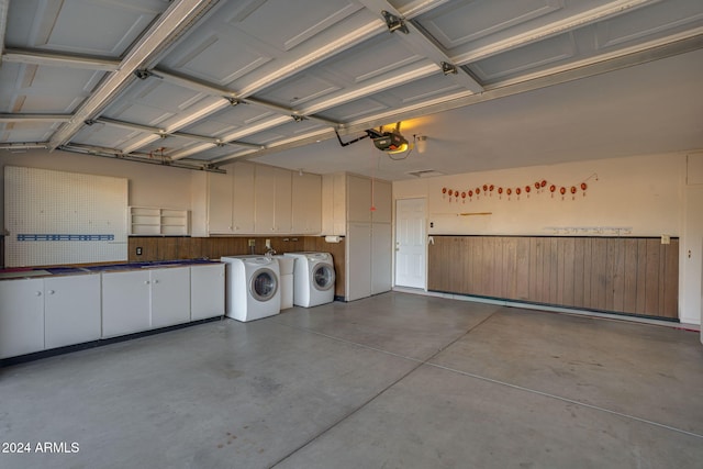 garage featuring washing machine and dryer and a garage door opener