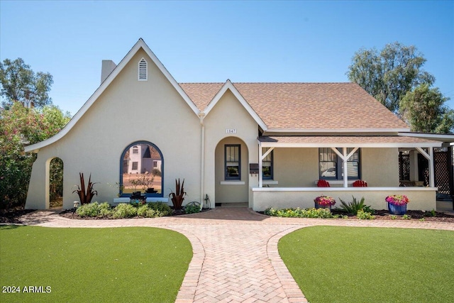 view of front facade with a front yard and a porch