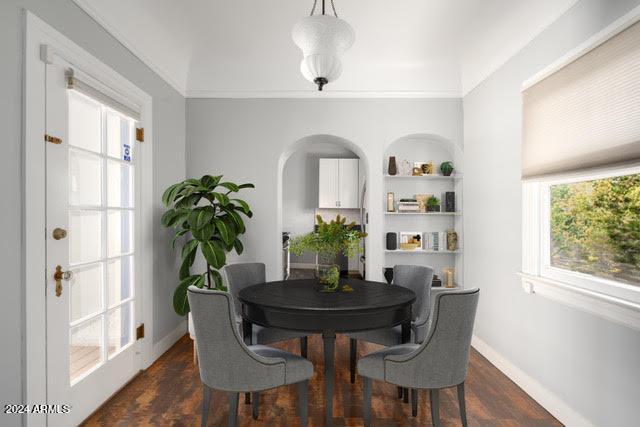 dining space with crown molding, plenty of natural light, and dark hardwood / wood-style flooring