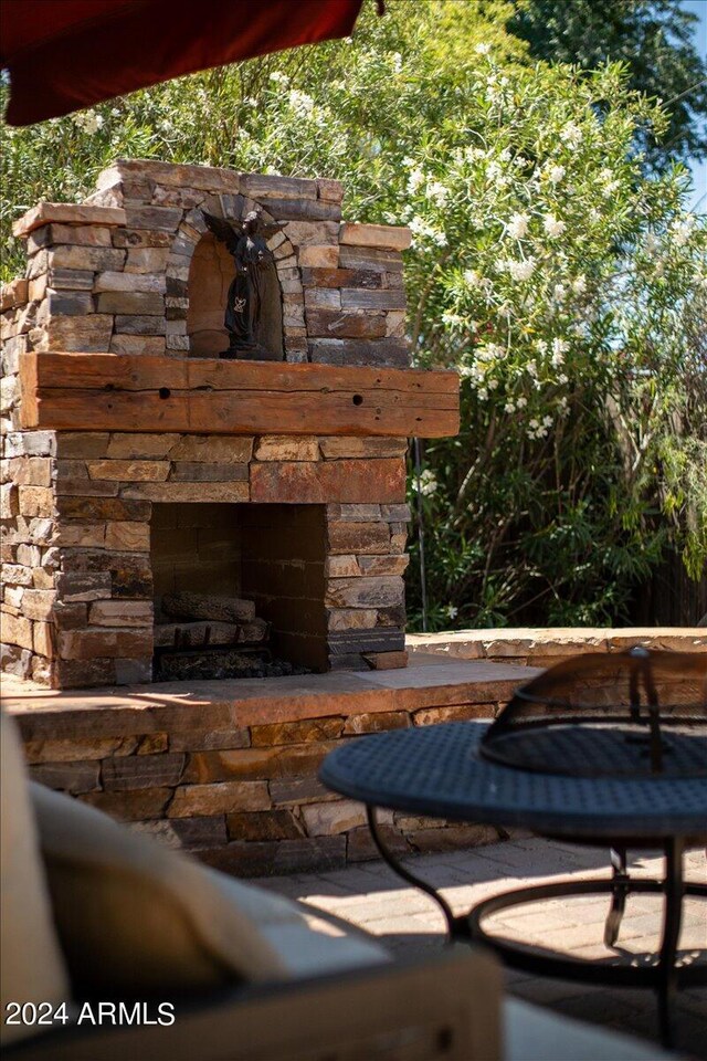 exterior details with an outdoor stone fireplace