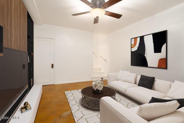 living room with light tile patterned floors and ceiling fan