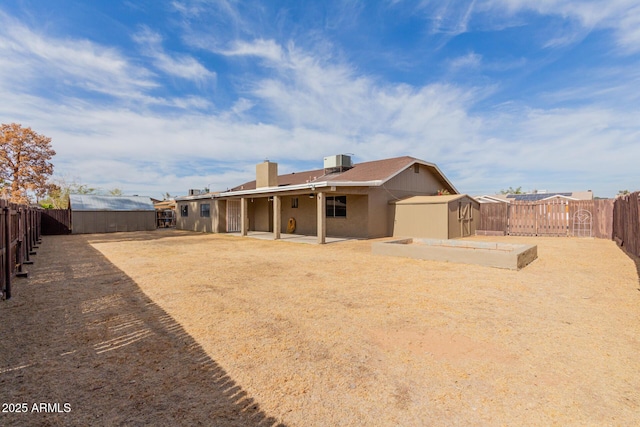 back of house featuring a patio area, central air condition unit, and a storage shed