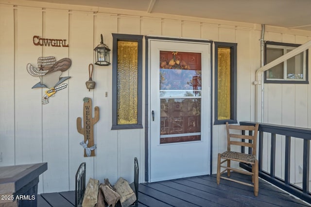 view of exterior entry with a porch