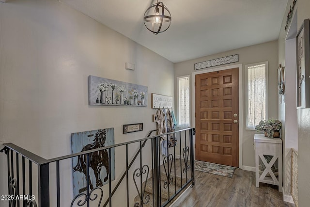 entrance foyer featuring baseboards and wood finished floors