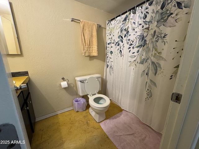 831 S Calle Virada, Sierra Vista, AZ 85635 - bathroom featuring vanity, toilet, unfinished concrete flooring, curtained shower, and baseboards