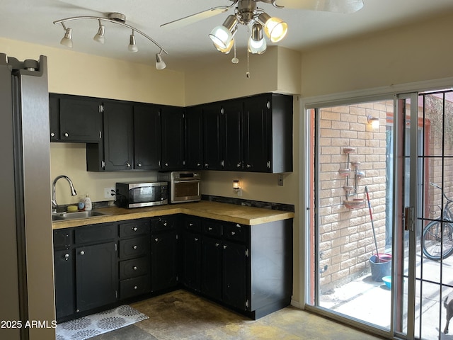 831 S Calle Virada, Sierra Vista, AZ 85635 - kitchen with stainless steel microwave, a sink, dark cabinets, ceiling fan, and light countertops