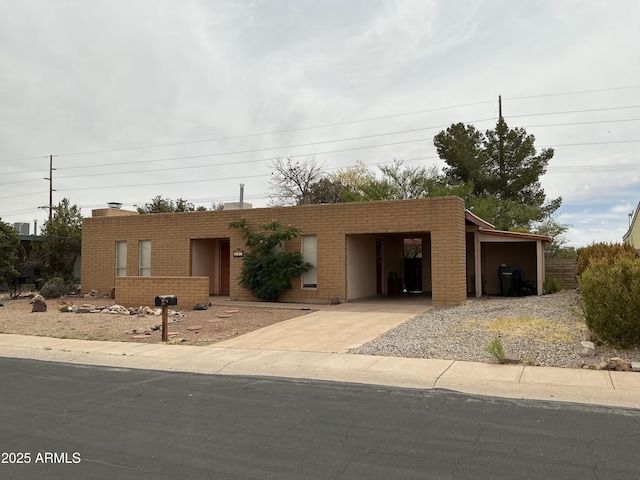 831 S Calle Virada, Sierra Vista, AZ 85635 - view of front facade featuring concrete driveway, an attached carport, and brick siding