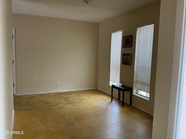 831 S Calle Virada, Sierra Vista, AZ 85635 - spare room featuring unfinished concrete flooring and baseboards
