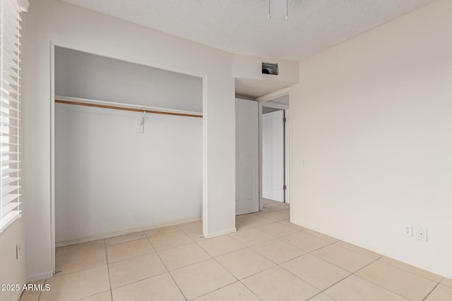 702 W Sequoia Dr, Phoenix, AZ 85027 - unfurnished bedroom featuring a closet, light tile patterned floors, a textured ceiling, and ceiling fan
