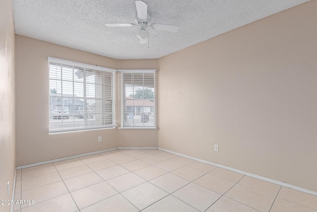 702 W Sequoia Dr, Phoenix, AZ 85027 - empty room featuring healthy amount of natural light, a ceiling fan, a textured ceiling, and light tile patterned floors