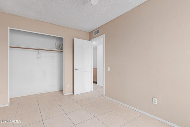 702 W Sequoia Dr, Phoenix, AZ 85027 - unfurnished bedroom with a textured ceiling, a closet, and light tile patterned floors