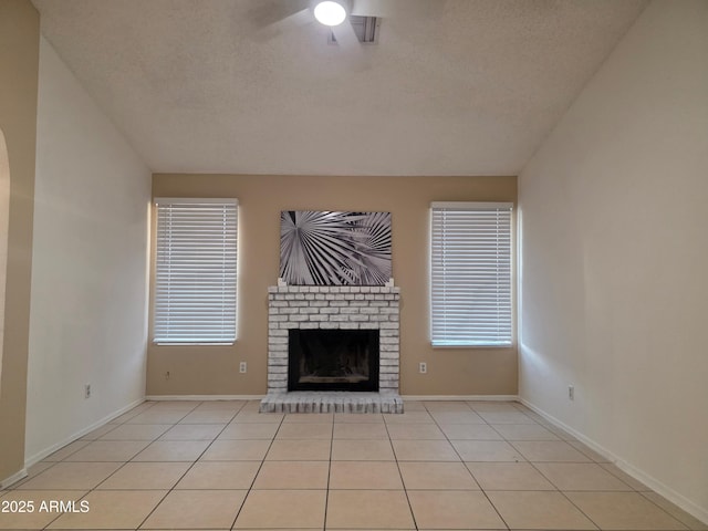 702 W Sequoia Dr, Phoenix, AZ 85027 - unfurnished living room with a textured ceiling, a brick fireplace, a ceiling fan, and light tile patterned flooring