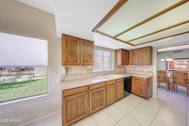 kitchen featuring visible vents, light countertops, a sink, and dishwasher