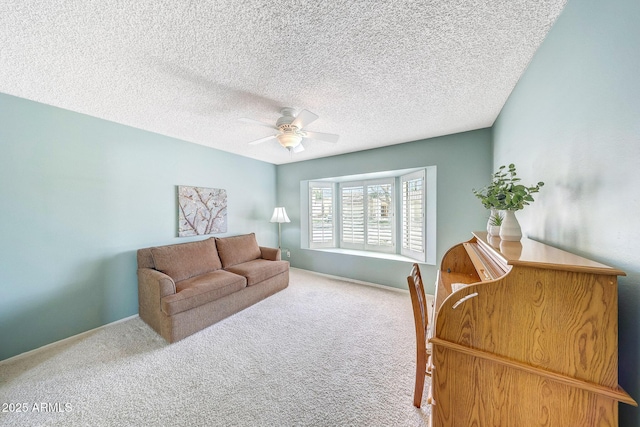 interior space featuring a ceiling fan, a textured ceiling, and baseboards