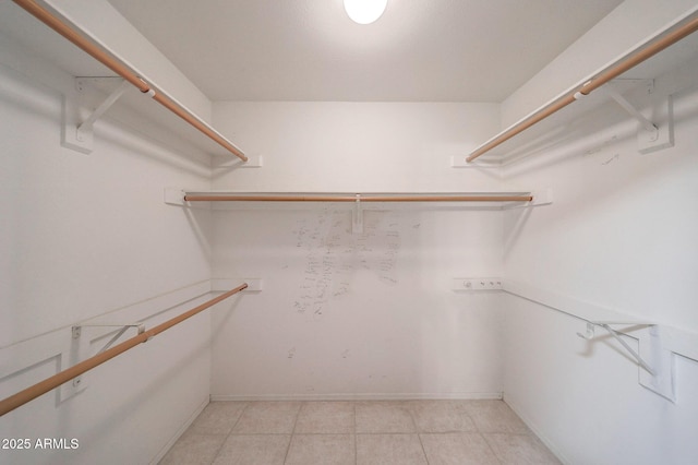 spacious closet with light tile patterned floors