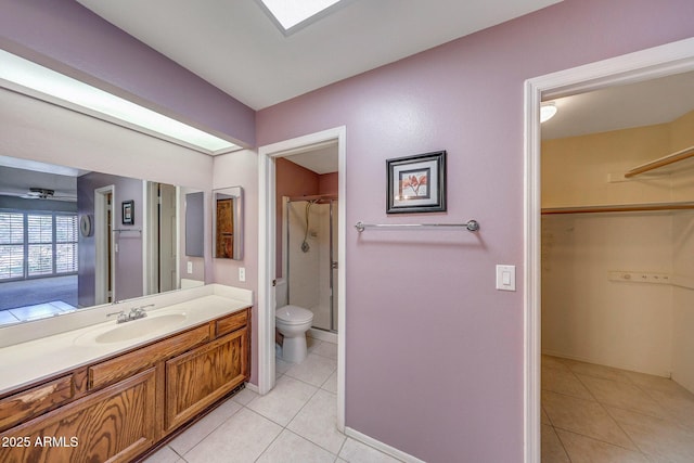 bathroom with vanity, tile patterned flooring, baseboards, and toilet