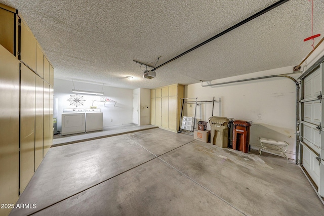 garage with washer and clothes dryer and a garage door opener